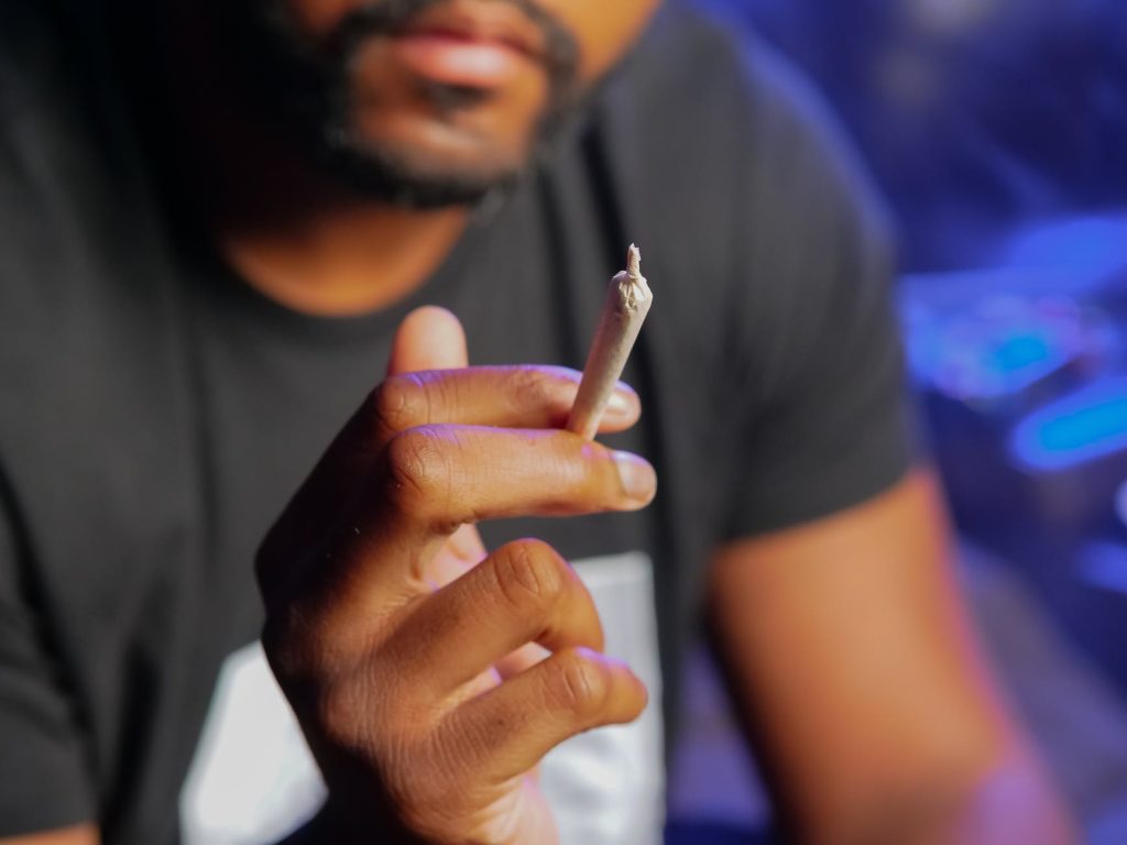 close up photo of person holding blunt