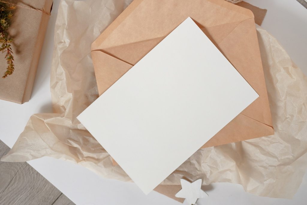 a white piece of paper sitting on top of a piece of brown paper