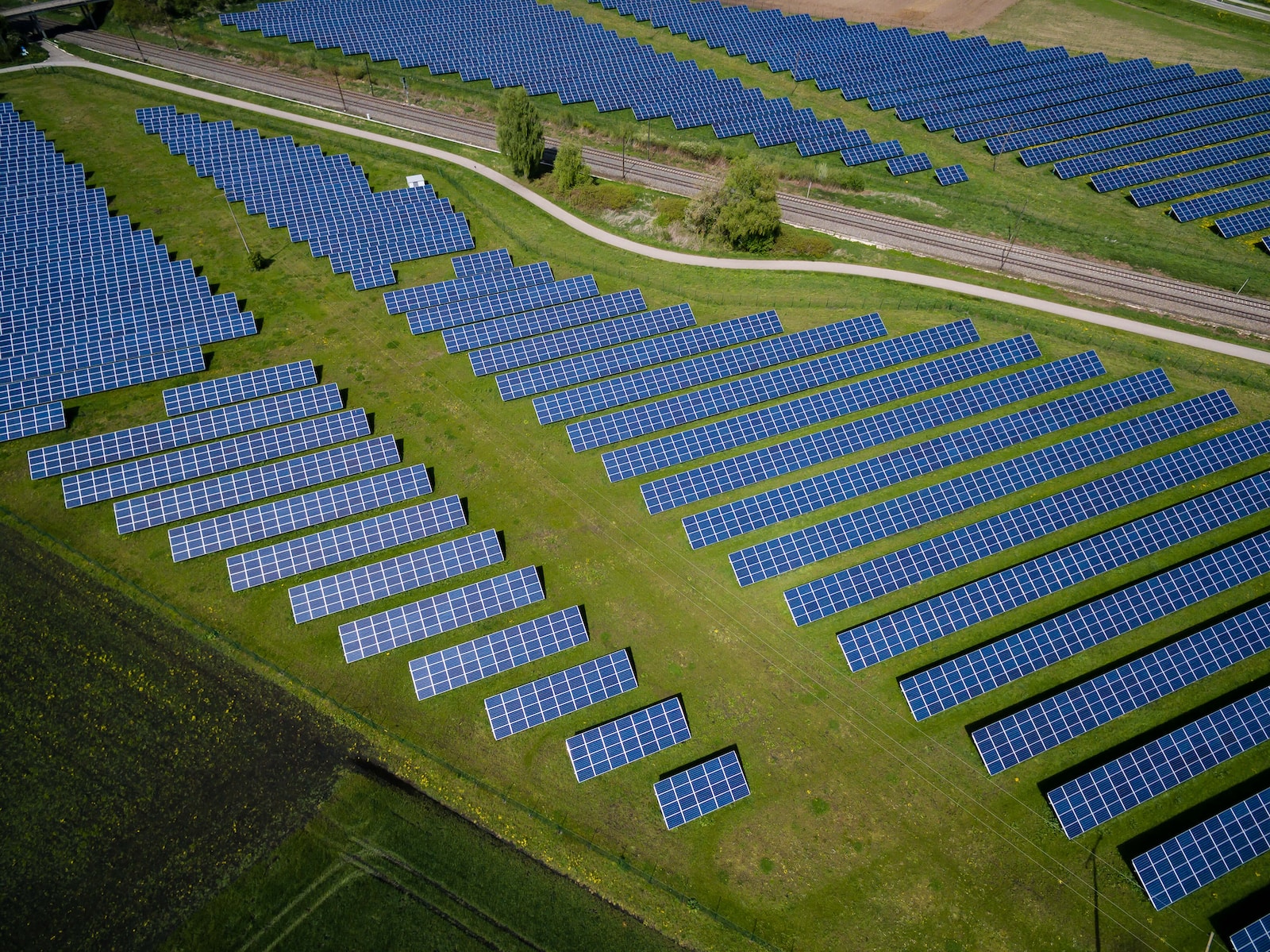 aerial photography of grass field with blue solar panels