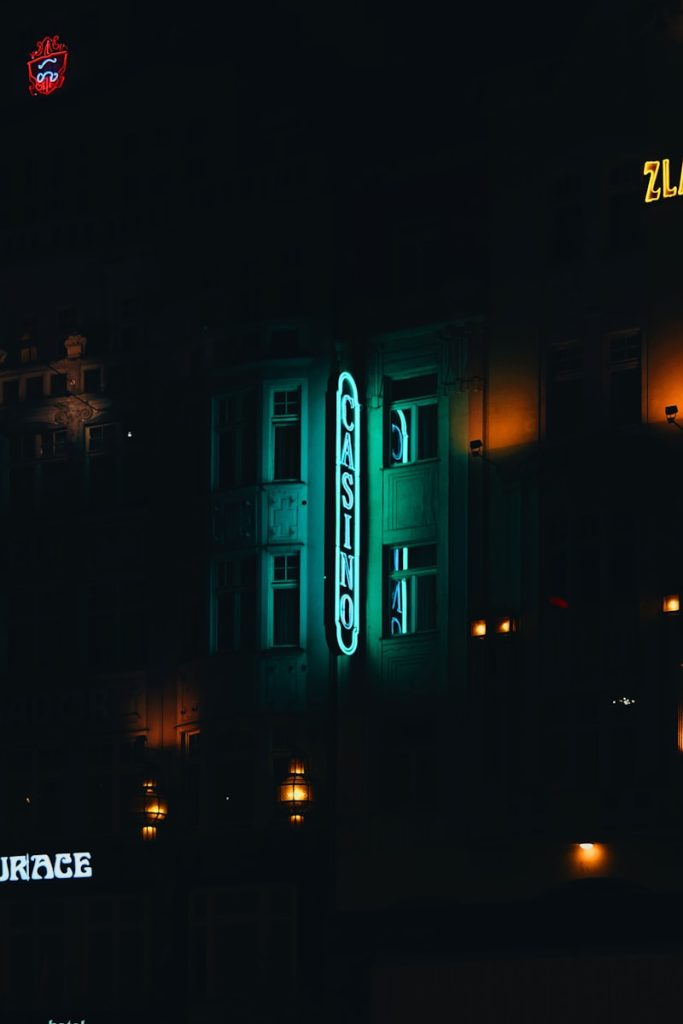 a building with a neon sign lit up at night