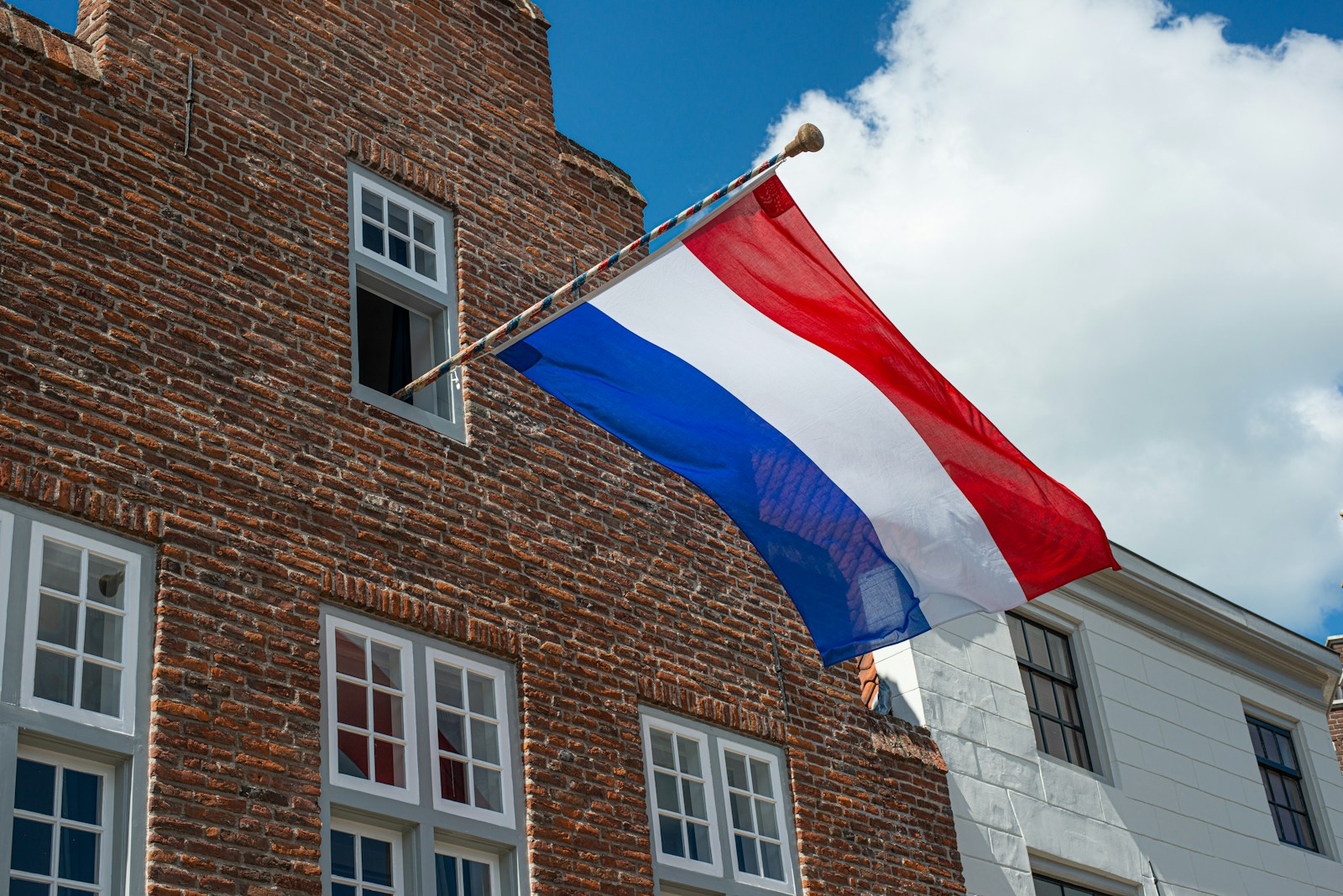 brown brick building with flag of america