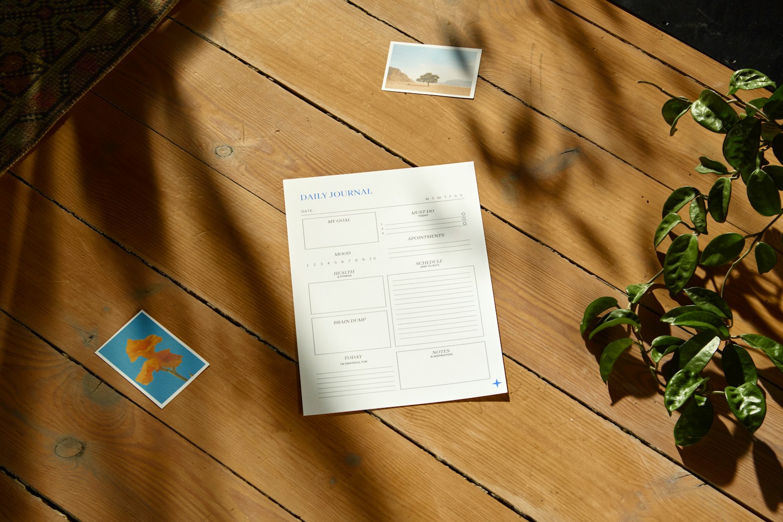 a wooden table topped with a plant and a piece of paper